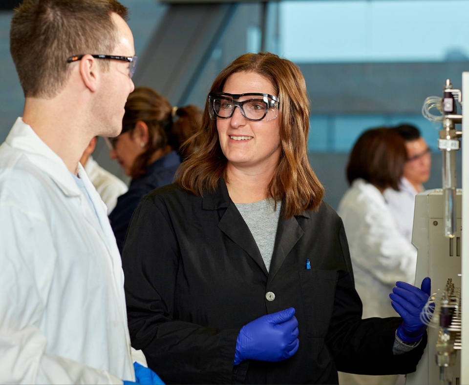 An instructor and student discussing a soil and water sample in the lab.