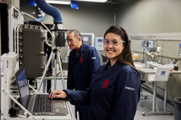 Engineer operating specialized equipment in a laboratory.