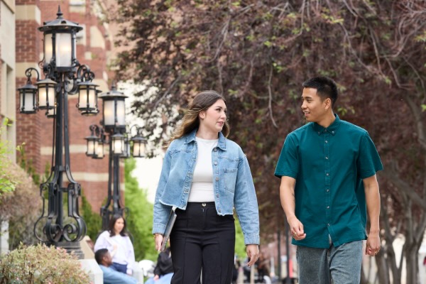 Two students talking outside SAIT campus.