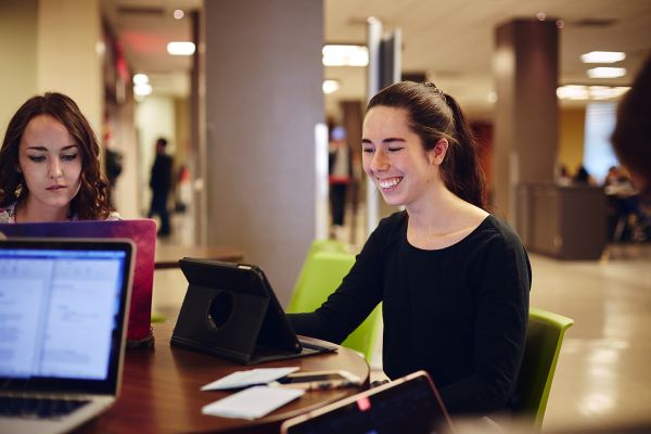 Group of students at a table using their computers