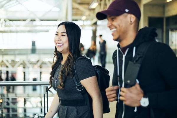 Two people walking indoors through Stan Grad